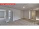 Upstairs loft with neutral carpet, several doorways, and ample natural light at 7330 Stonehouse Dr, Gastonia, NC 28056