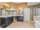 Bathroom featuring double vanity with cabinets, tile floor, and separate shower and tub at 9013 Gailes Dr, Charlotte, NC 28278