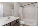 Bathroom with shower, tub and vanity with dark cabinets at 9013 Gailes Dr, Charlotte, NC 28278