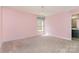 Bedroom has pink walls, carpet and a chandelier light fixture at 9013 Gailes Dr, Charlotte, NC 28278