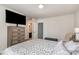 Neutral bedroom featuring a TV, dresser, and doorway to bathroom at 9013 Gailes Dr, Charlotte, NC 28278