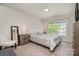 Cozy bedroom with a large window offering natural light and neutral carpeting at 9013 Gailes Dr, Charlotte, NC 28278