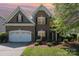 Charming two-story brick home with a well-manicured lawn and a two-car garage at 9013 Gailes Dr, Charlotte, NC 28278