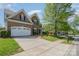 Beautiful brick home featuring a spacious driveway, two-car garage, and a lovely front yard at 9013 Gailes Dr, Charlotte, NC 28278