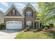 Charming two-story brick home with a well-manicured lawn and a two-car garage at 9013 Gailes Dr, Charlotte, NC 28278