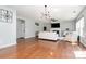 Living room with hardwood floors, modern lighting, and a fireplace at 9013 Gailes Dr, Charlotte, NC 28278