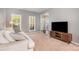Inviting living room with neutral tones, modern furnishings, and ample natural light through large windows at 9013 Gailes Dr, Charlotte, NC 28278