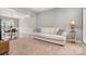 Comfortable living room featuring a plush sofa and a partial view of the dining area at 9013 Gailes Dr, Charlotte, NC 28278