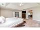 Bright main bedroom with white ceiling, neutral paint, ensuite entrance, and neutral carpeting at 9013 Gailes Dr, Charlotte, NC 28278