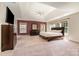 Spacious main bedroom with a tray ceiling, ample natural light, and neutral carpeting at 9013 Gailes Dr, Charlotte, NC 28278