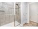 Well-lit shower features tile and glass door, offering a spa-like experience at 9654 Old Garden Cir, Gastonia, NC 28056