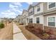 Row of charming townhomes with manicured lawns and sidewalks offer a welcoming neighborhood appeal at 9654 Old Garden Cir, Gastonia, NC 28056