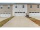 Three-car garage with white doors and long driveway offers ample parking space in a multi-Gathering setting at 9654 Old Garden Cir, Gastonia, NC 28056
