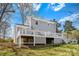 View of the backyard showing the home's deck and foundation at 9718 Barkridge Rd, Mint Hill, NC 28227