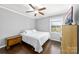 Cozy bedroom with hardwood floors, a ceiling fan, and natural light at 9718 Barkridge Rd, Mint Hill, NC 28227