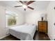 Bright bedroom with hardwood floors, a ceiling fan, and natural light at 9718 Barkridge Rd, Mint Hill, NC 28227