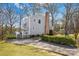 Exterior view of a two-story home with mature trees, large backyard, and long driveway at 9718 Barkridge Rd, Mint Hill, NC 28227