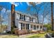 Charming two-story home featuring a brick chimney and inviting front porch at 9718 Barkridge Rd, Mint Hill, NC 28227