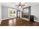 Bright living room features a decorative fireplace, hardwood floors, and lots of natural light at 9718 Barkridge Rd, Mint Hill, NC 28227