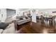 Open concept living room featuring hardwood floors and view into kitchen at 9718 Barkridge Rd, Mint Hill, NC 28227