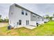 Backyard featuring a concrete patio and lawn, creating a private outdoor space at 10002 Brittondale Ln, Charlotte, NC 28215