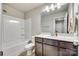 Bathroom featuring a shower, toilet, and vanity with a sink and modern lighting at 10002 Brittondale Ln, Charlotte, NC 28215