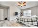 Spacious bedroom featuring vaulted ceilings, modern ceiling fan, and large window at 10002 Brittondale Ln, Charlotte, NC 28215