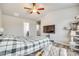 Spacious bedroom featuring vaulted ceilings, modern ceiling fan, and large window at 10002 Brittondale Ln, Charlotte, NC 28215