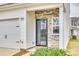Close-up of the front door with decorative stone detail and a small garden area at 10002 Brittondale Ln, Charlotte, NC 28215