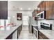 Spacious kitchen with stainless steel appliances, dark wood cabinets, and granite countertops at 10002 Brittondale Ln, Charlotte, NC 28215