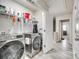 Laundry room with washer, dryer, storage shelf and an entryway into the hall at 10002 Brittondale Ln, Charlotte, NC 28215