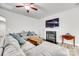 Inviting living room featuring a fireplace, large sectional sofa, and a ceiling fan at 10002 Brittondale Ln, Charlotte, NC 28215