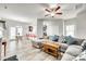 Bright living room with a comfortable sectional sofa, modern ceiling fan, and view of the dining area at 10002 Brittondale Ln, Charlotte, NC 28215