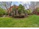 Well-manicured backyard featuring a lush green lawn, mature trees, and attractive landscaping at 104 Chalfont Ct, Salisbury, NC 28147