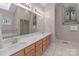 Bathroom with long vanity, dual sinks, and a large mirror at 104 Chalfont Ct, Salisbury, NC 28147