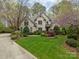 Stately brick home with well-maintained lawn, mature trees, and colorful landscaping in a desirable neighborhood at 104 Chalfont Ct, Salisbury, NC 28147