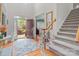 Bright foyer with hardwood floors, staircase, and open doorway invites guests into this beautiful home at 104 Chalfont Ct, Salisbury, NC 28147