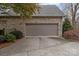 Spacious two-car garage featuring a brick exterior, a wide driveway, and mature landscaping at 104 Chalfont Ct, Salisbury, NC 28147