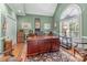 Well-appointed home office with ample natural light, hardwood floors, and sophisticated furnishings, creating a productive workspace at 104 Chalfont Ct, Salisbury, NC 28147