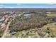 Expansive aerial view of a neighborhood with mature trees, a lake, and surrounding landscape at 109 Connor Ct, Kings Mountain, NC 28086