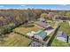 Aerial view of home with spacious fenced yard, detached garage, and surrounding trees at 109 Connor Ct, Kings Mountain, NC 28086