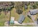 Aerial view of home with spacious fenced yard, detached garage, and surrounding trees at 109 Connor Ct, Kings Mountain, NC 28086