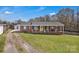 Charming brick ranch home with a cozy front porch, yellow door, and spacious front yard at 109 Connor Ct, Kings Mountain, NC 28086