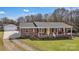 Charming brick ranch home with a cozy front porch and inviting yellow front door at 109 Connor Ct, Kings Mountain, NC 28086