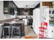 A functional kitchen has dark cabinets, an island with seating and neutral countertops at 109 Connor Ct, Kings Mountain, NC 28086