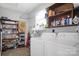 This laundry room includes shelving, appliances and storage space at 109 Connor Ct, Kings Mountain, NC 28086