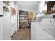 This laundry room includes shelving, appliances, an exterior door and storage space at 109 Connor Ct, Kings Mountain, NC 28086