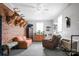 Eclectic living room featuring brick accent wall with unique furnishings and decor at 109 Connor Ct, Kings Mountain, NC 28086