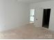 Bright bedroom featuring neutral walls and an ensuite bathroom entrance at 1110 Sugar Creek Rd, Indian Land, SC 29707