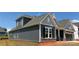 Exterior corner view of home with gray siding, stone accents, and a view of garage at 1110 Sugar Creek Rd, Indian Land, SC 29707